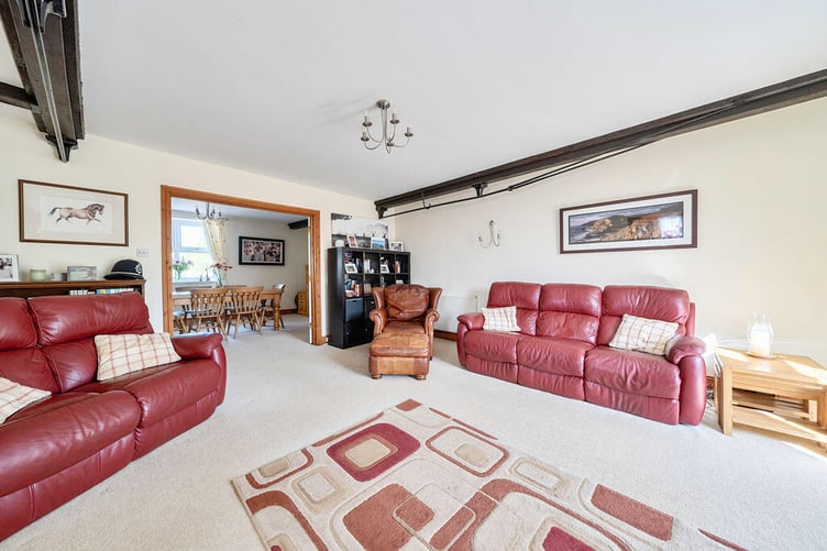 The main spacious sitting room enjoys ample space for everyday soft furnishings and overlooks the rear garden via French doors