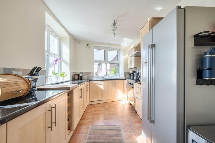 There is a well-equipped dual aspect kitchen offering an array of matching wall and base units
