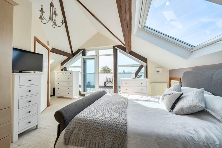 The master suite is accessed via a further staircase and is fitted with wardrobes, two Velux windows along with French doors with recently installed electric blinds and solar glass to reflect heat