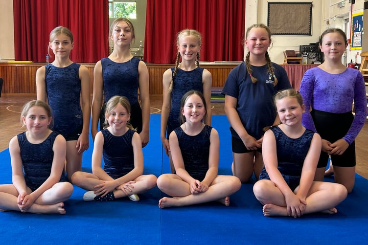 A group of the advance gymnasts on the recently purchased mats