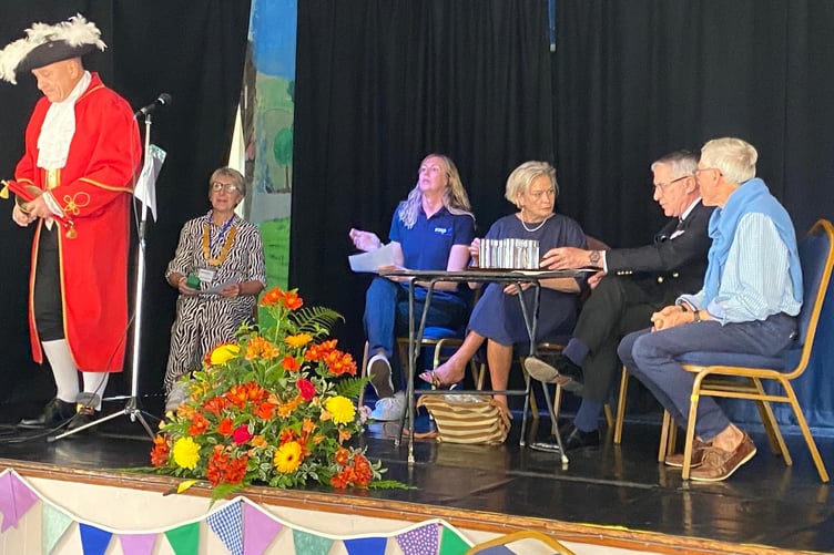 Porlock town crier Grant Dennis and speakers at the launch of Porlock Vale CIC community services initiative.