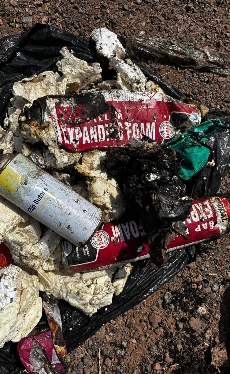 The remains of a bag which caught fire in the back of a Minehead bin lorry were found to include a lithium battery and a number of aerosol cans and expanding foam.
