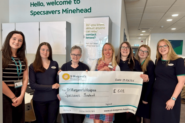 Specsavers Minehead staff with a cheque for St Margaret's Hospice boosted by customers.
