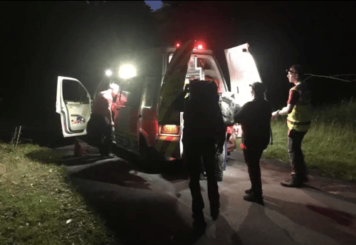 Exmoor Search and Rescue Team help an injured walker into the back of an ambulance.
