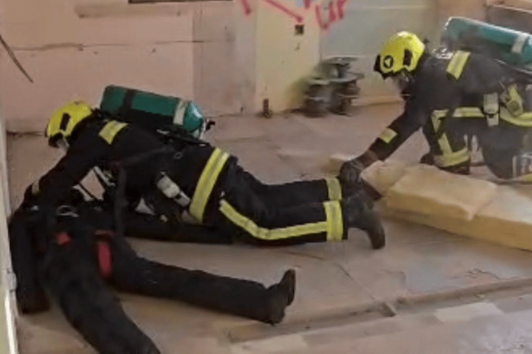 A Minehead fire crew carry out a training rescue exercise in a house loaned to the brigade before renovation work starts.
