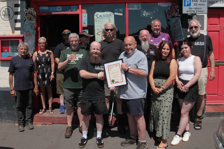 CAMRA's Bob Southwell, centre right, presents an award to Pebbles tavern landlord Sean Graham. Also pictured are Somerset CAMRA chairman Mick Cleveland, CAMRA transport manager Phil Emonds, and staff members Rosie Clayton and Tyler Johnson. PHOTO: George Ody.