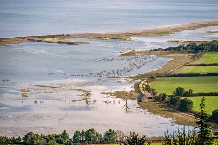 View over Porlock Marsh, flooded at high spring tide to Hurlstone Point, from the Porlock Toll Road, Exmoor National Park