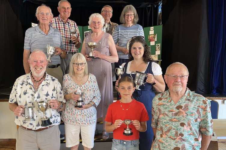Trophy winner in Porlock Horticultural and Crafts Society summer show are (rear) Peter Leather, Geoff Garfield, Sue Appleton, Malcolm Appleton Susan Locke, and (front) Paul Murch, Pam Molford, Chloe Denton, and Catherine Greer, with Jim Moon.