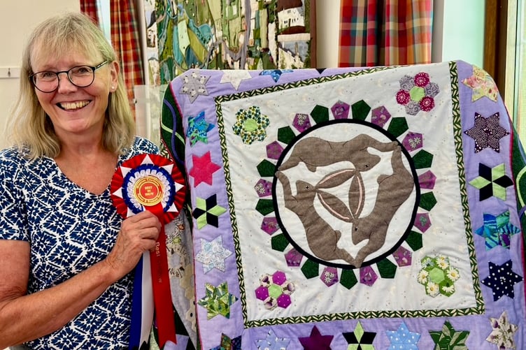Roz Griffin with her magnificent quilt, which won 'Best in Show' at Wootton Courtenay Flower and produce Show. PHOTO: Bill Hodgson.