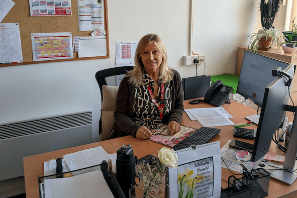 Linda Carroll behind her desk in Butlin's Minehead holiday resort, where she has worked for 45 years of the company's 90 years in business.