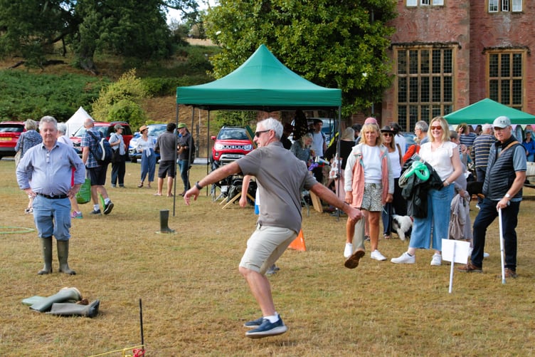 Nettlecombe Fete welly wanging competitors may have needed the wellies for another reason as torrential rain swept the area but failed to dampen spirits. PHOTO: George Ody.