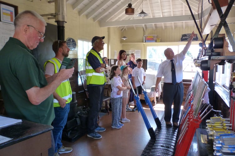 Young carers and their parents are shown the workings of the West Somerset Railway signal box at Bishops Lydeard during a day out organised by the Rotary Club of Minehead.