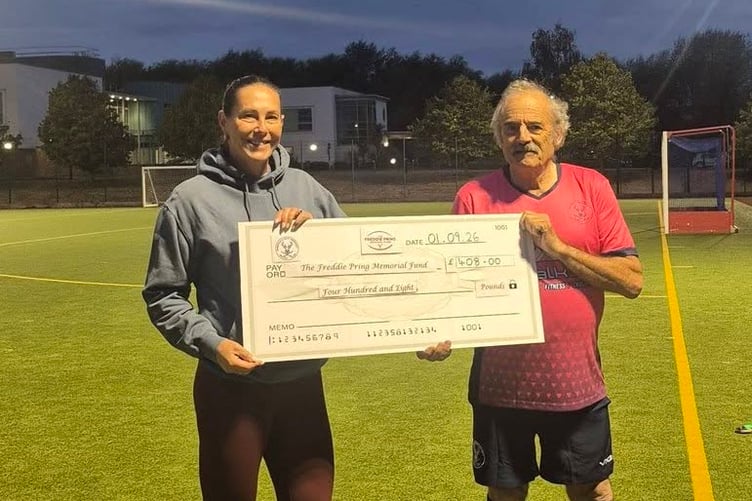 Club president Mark Collins hands over cheque to Freddie Pring Memorial Fund