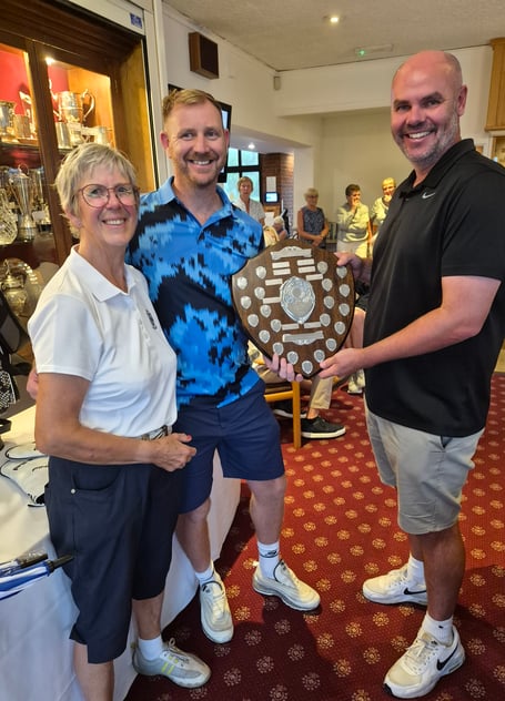 Winners of the Arnold Palmer Shield - Daniel Kelly (left) and Keegan Jones (right) - receiving the shield from Lady Capt Jenny Elliott