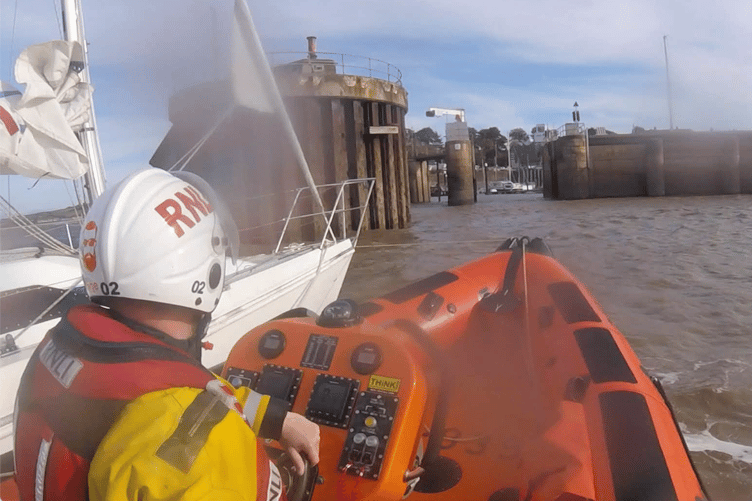 A Minehead lifeboat crew towing a yacht with engine trouble into Watchet Marina.