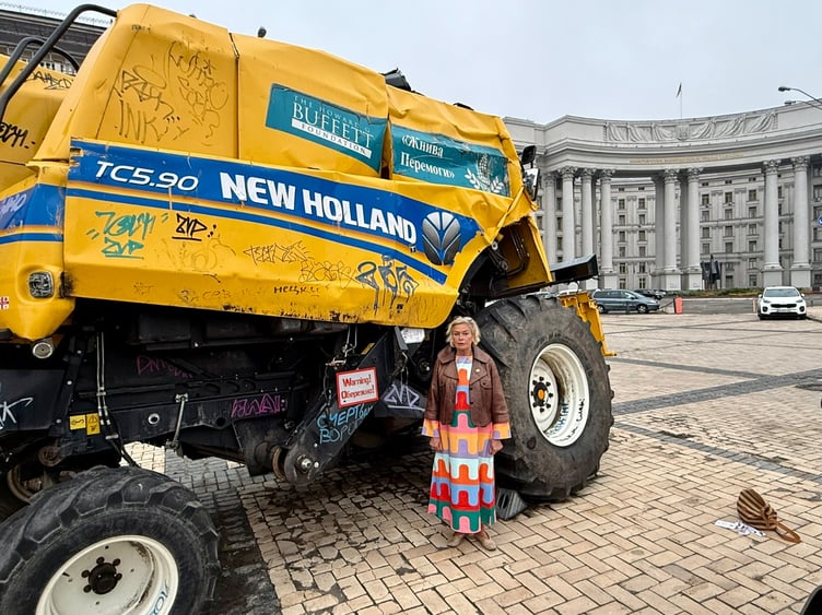 West Somerset MP Rachel Gilmour beside a bomb damaged combine harvester during a visit to Ukraine.