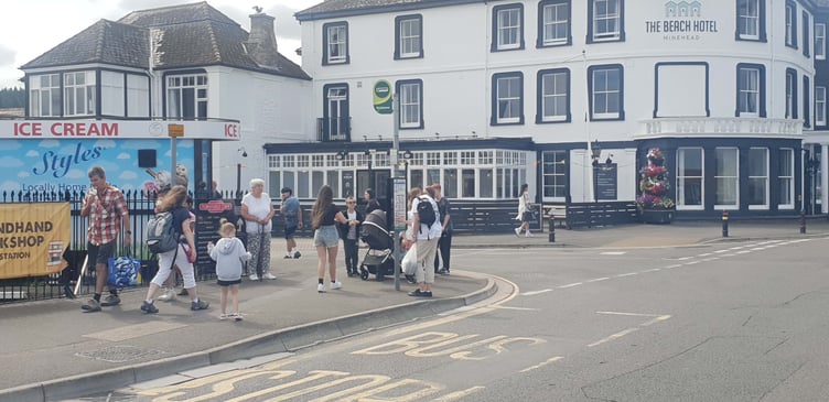 The Minehead sea front bus stop where waiting passengers have to stand in all weather without shelter or a seat.