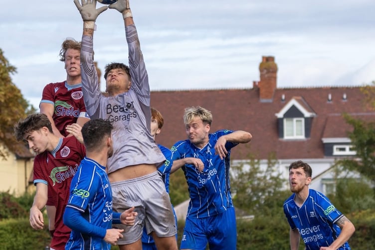 Minehead goalkeeper Tomasz Kubaczewski in action against North Petherton