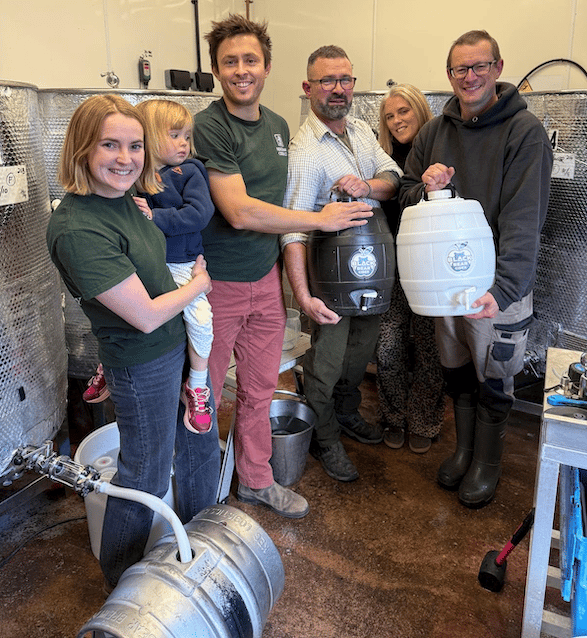 Pictured with some of the first batch of the new cider are (left to right) Rose and Jake Sharland-Hassell with daughter Clementine, Millie and Jon Coward, and Black Bear Brewery head brewer Tom Davies.