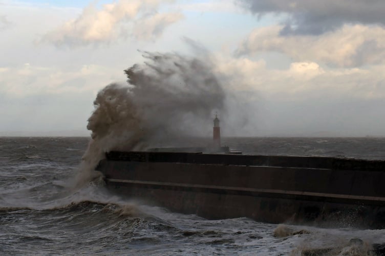 The Watchet Harbour lighthouse is deluged by waves as Storm Austen strikes.