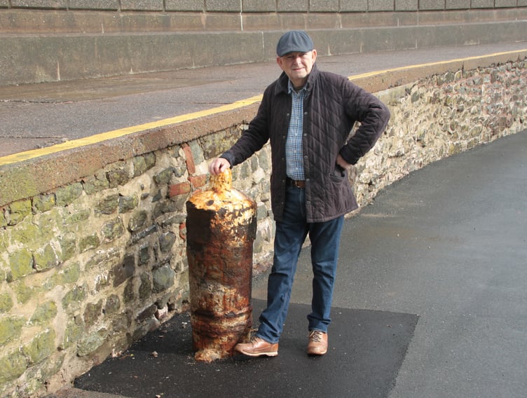 Former Minehead town councillor Michael Burke examines one of the cannons which have been returned after three years to the town's harbour. PHOTO: George Ody.